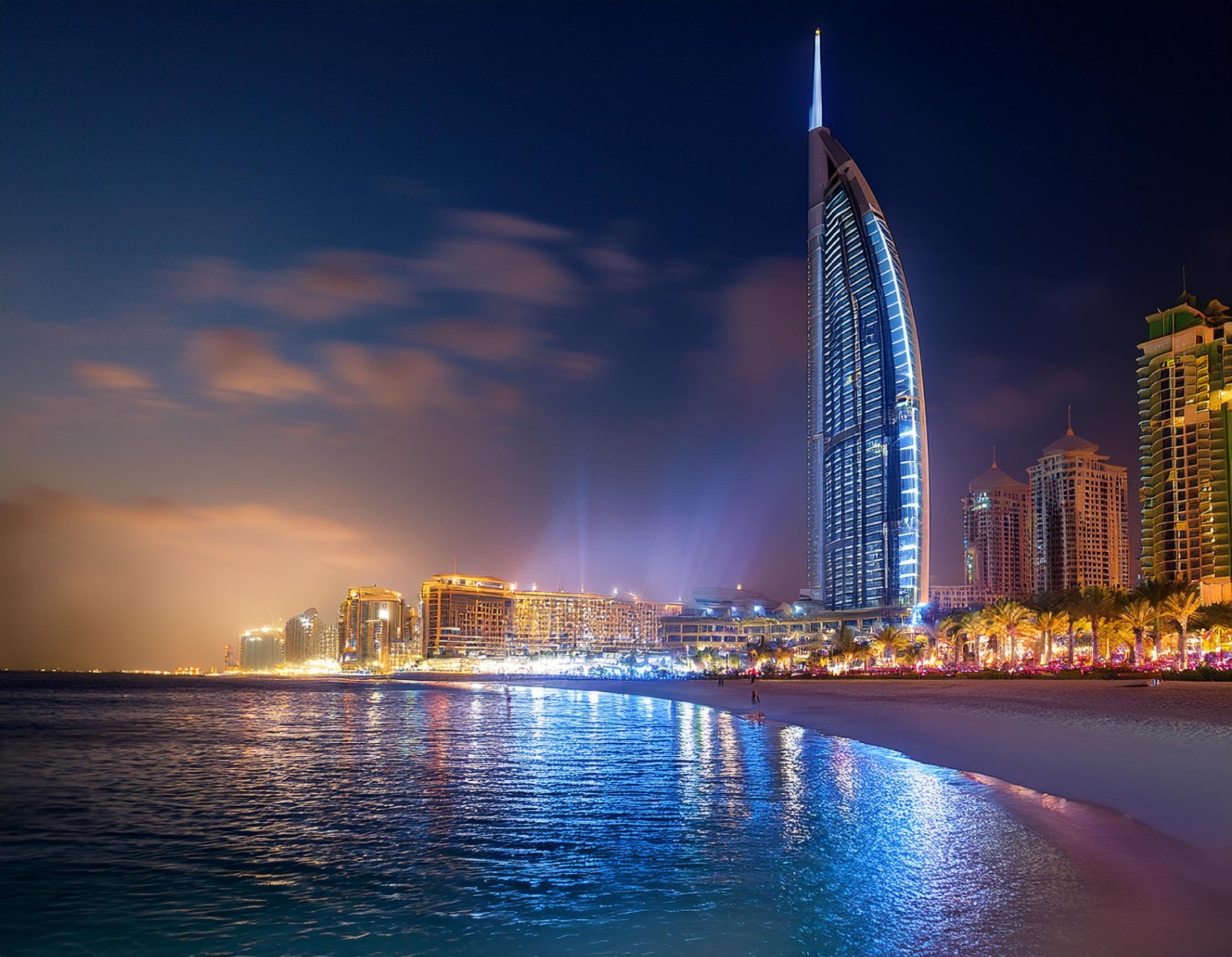 Burj Al Arab illuminated at night on the Jumeirah coast